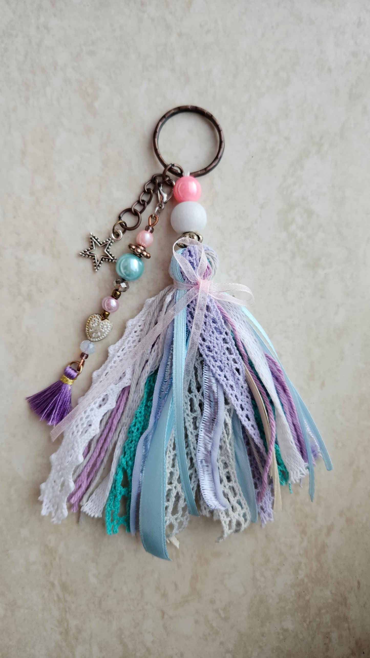 Charm with star pendant and ribbons
