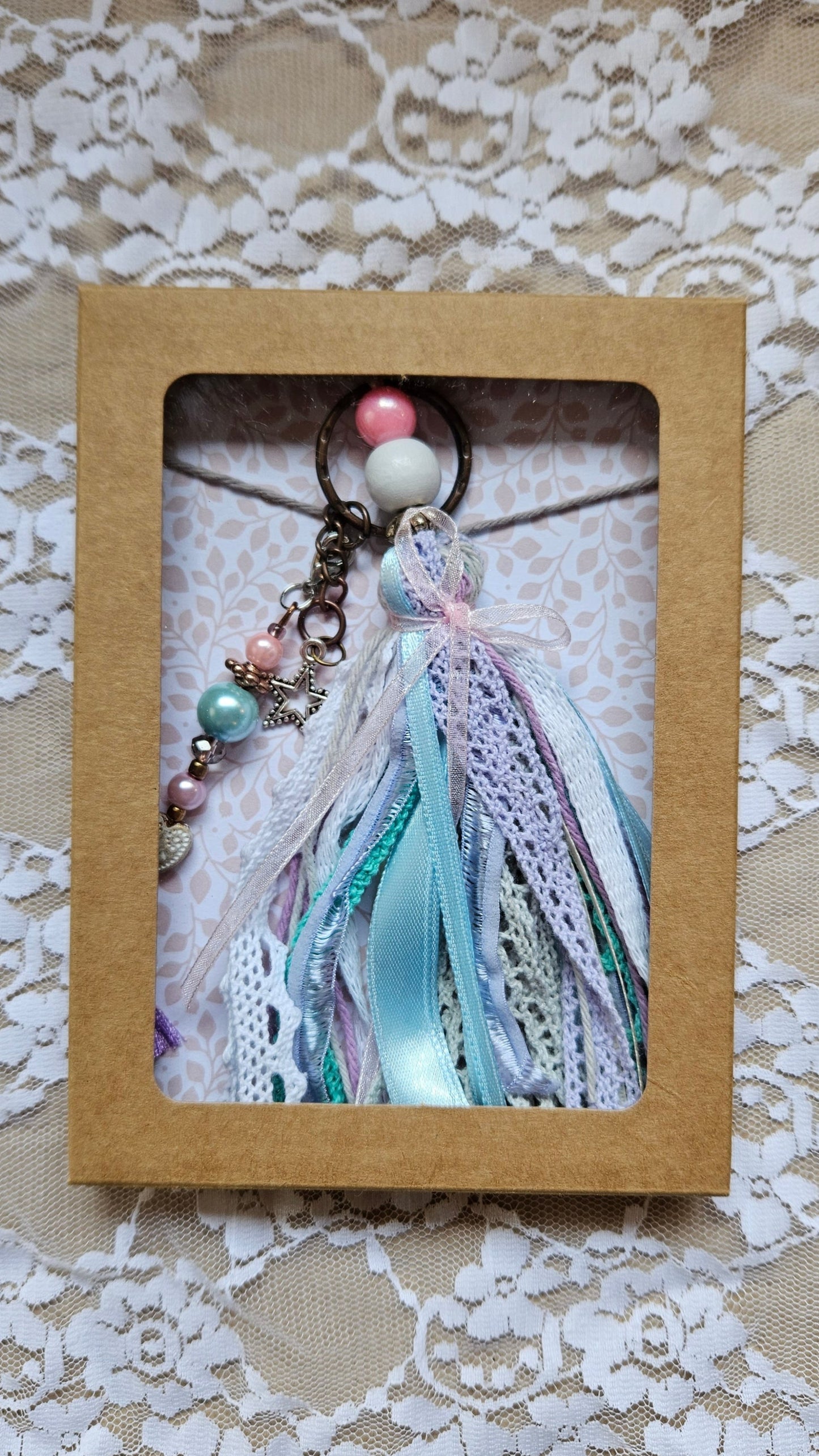 Charm with star pendant and ribbons