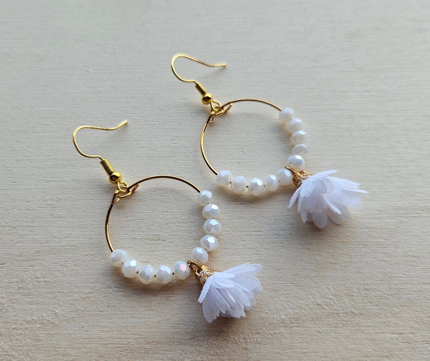 Gold hoop earrings with white flower
